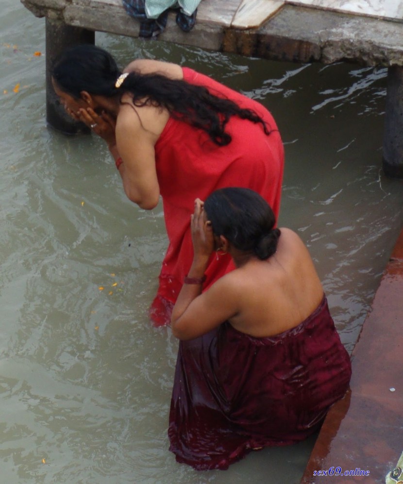 Asian women wash in the river