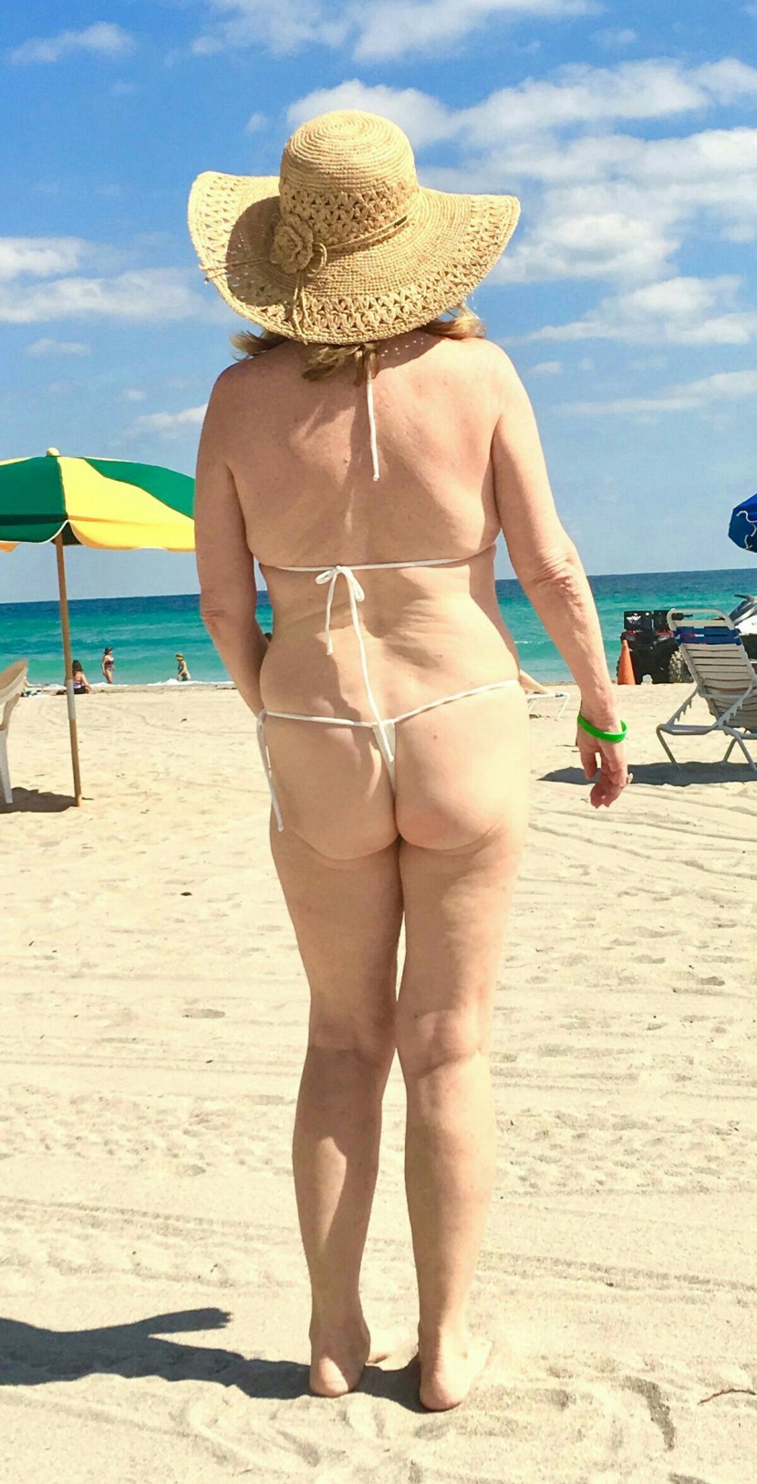Public beach of old woman Topless