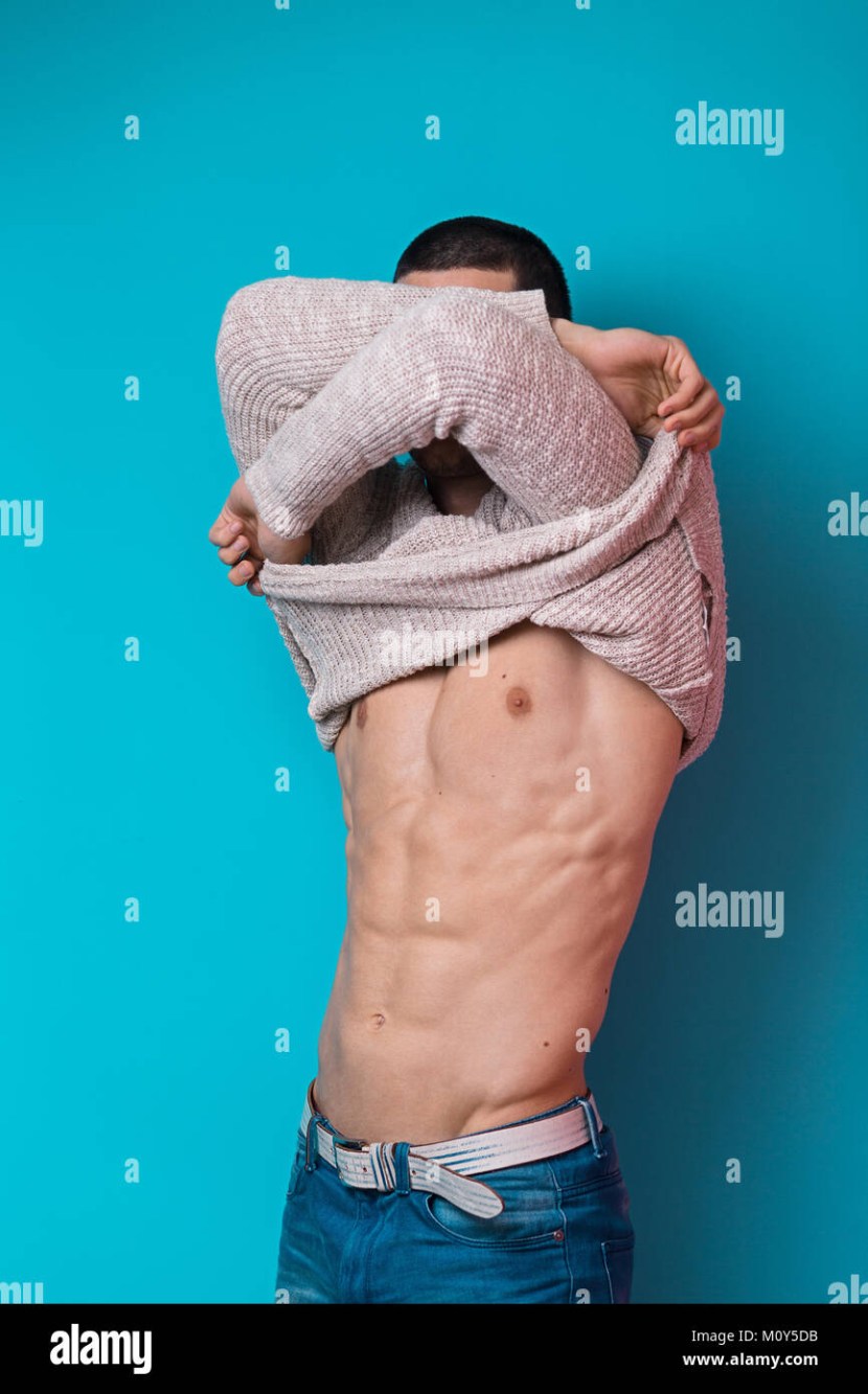 A person takes off a sweater