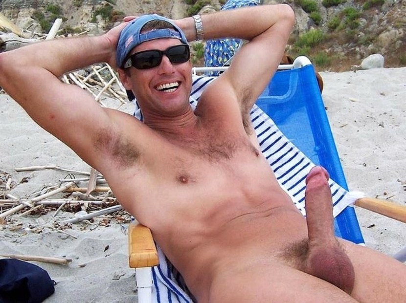 Adult man with a member on the beach