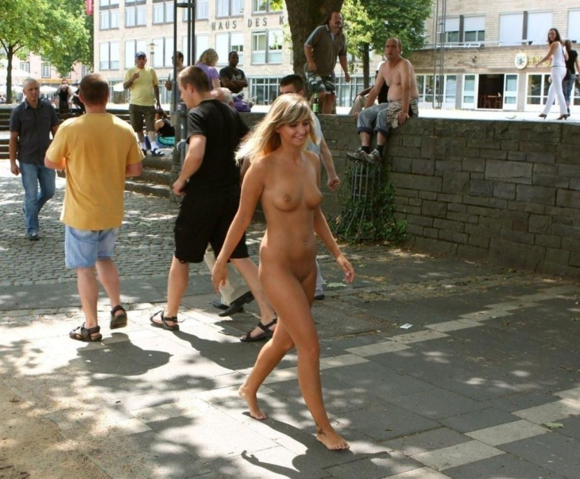 The girl undresses in a public place