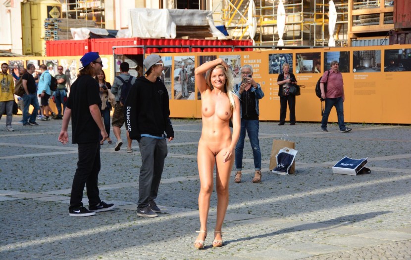 The girl undresses in a public place