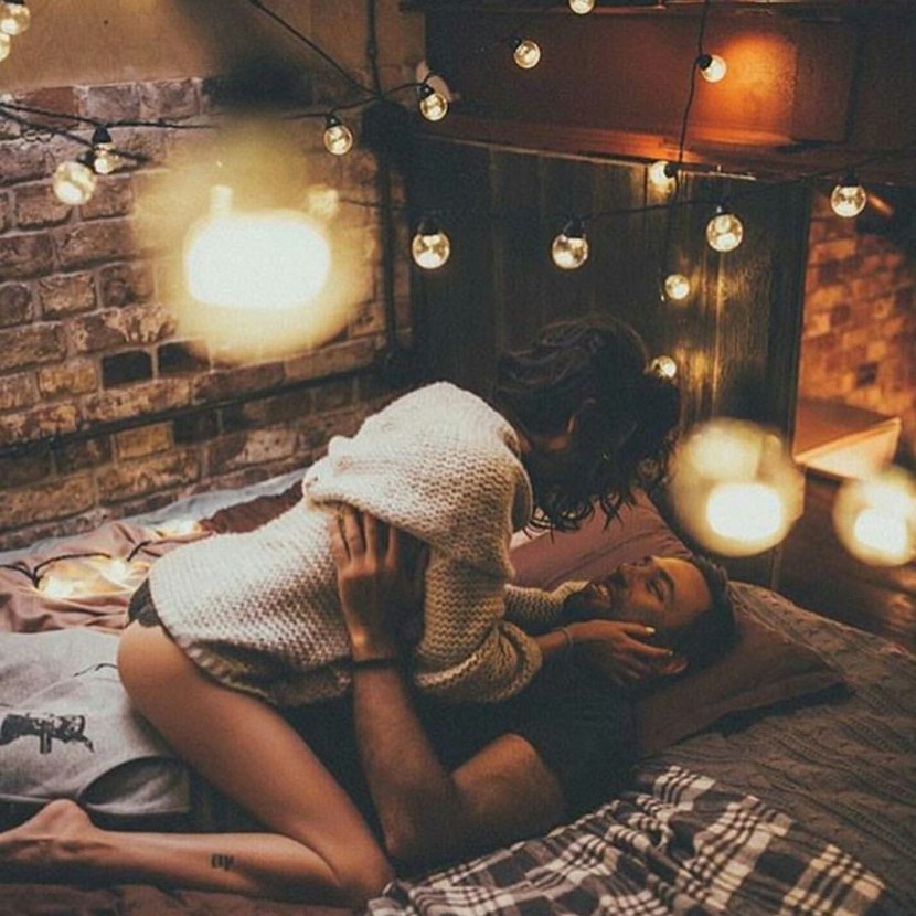 A woman sits on a man