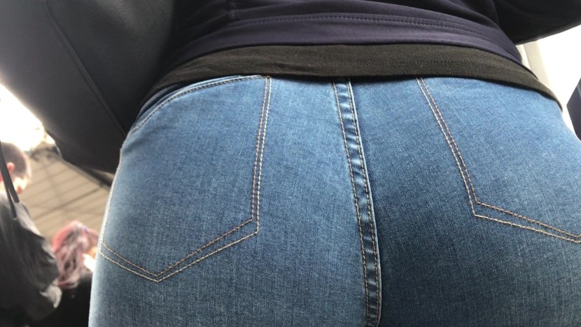 Men's hand in women's jeans