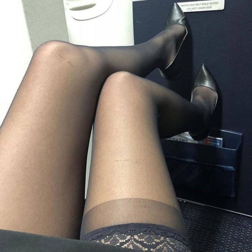 Legs in stockings under the table