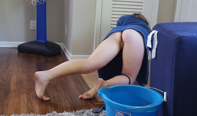 A naked woman is cleaning