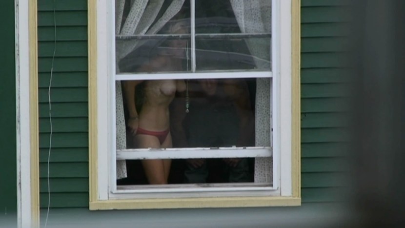 Naked women in the windows of houses