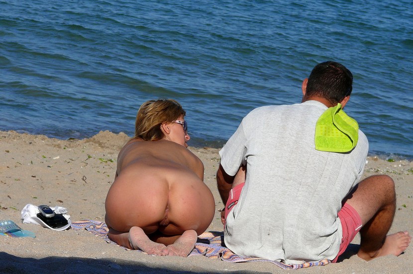 Naked butt on a nudist beach