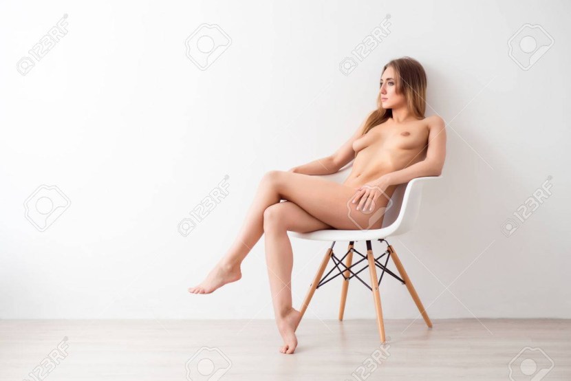 Naked women sitting in a chair