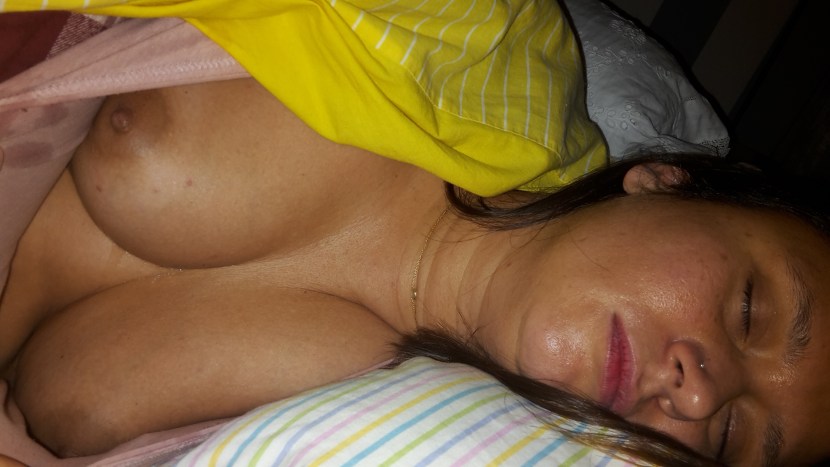 Breasts of a sleeping wife without a face from a mobile