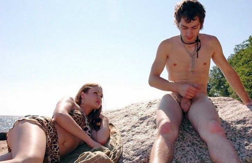 Naked man dressed woman on the beach