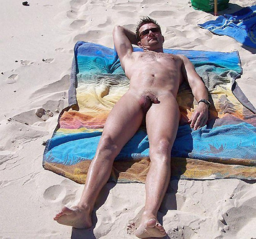 Naked guys sunbathe on the beach