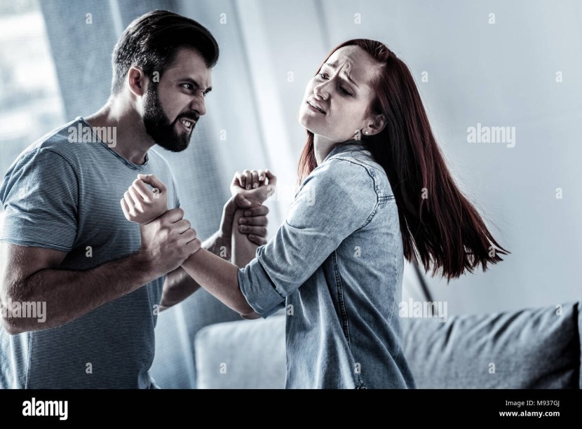 Muscular man hugs a girl