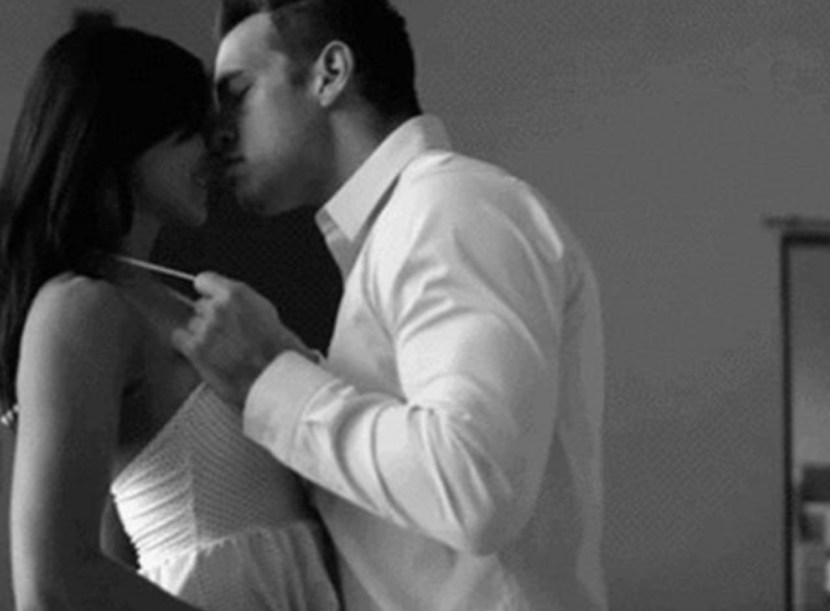 A guy with a girl in the bedroom