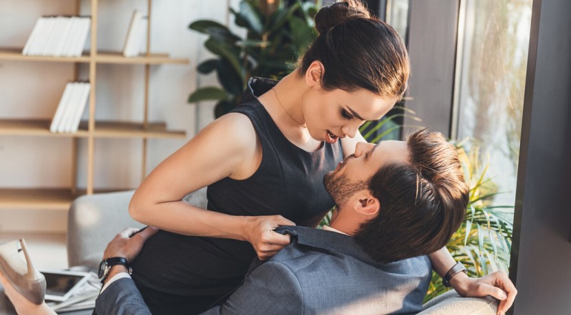 The silhouette man holds a woman in his arms