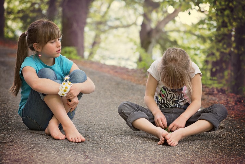 A red -haired child sits with his back