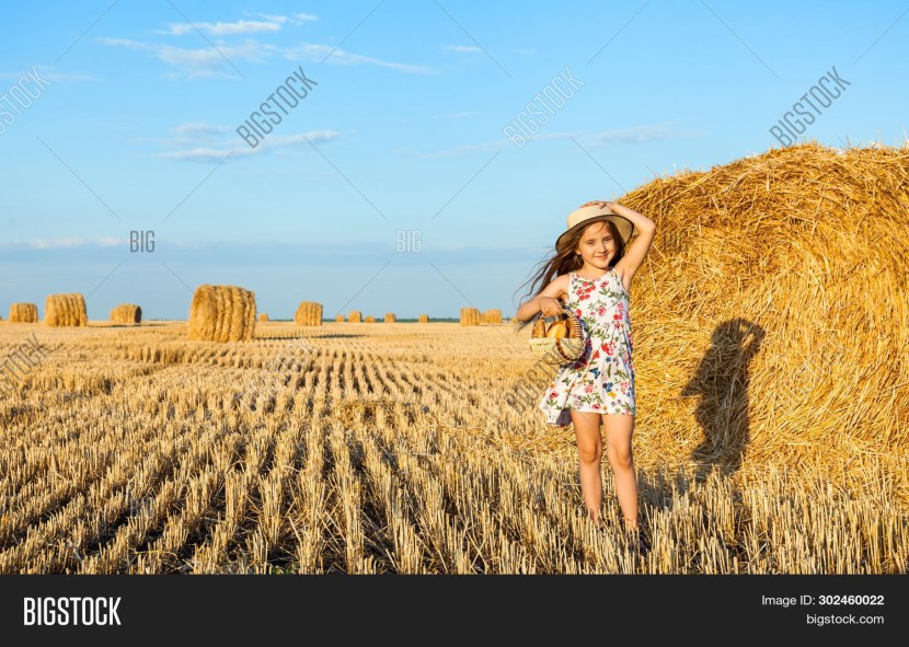 Photo shoot on hay stacks in a hat