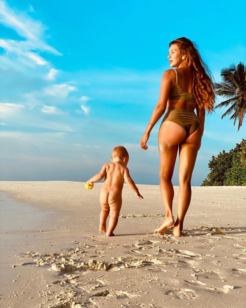 Regina Todorenko in a swimsuit with her son
