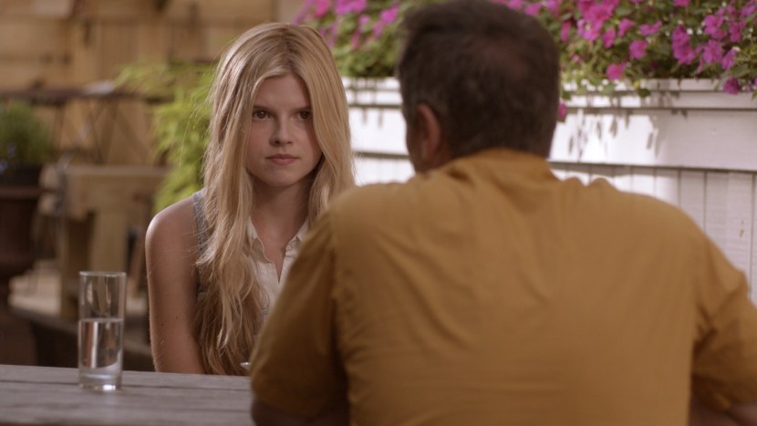 Girl in a dress sits