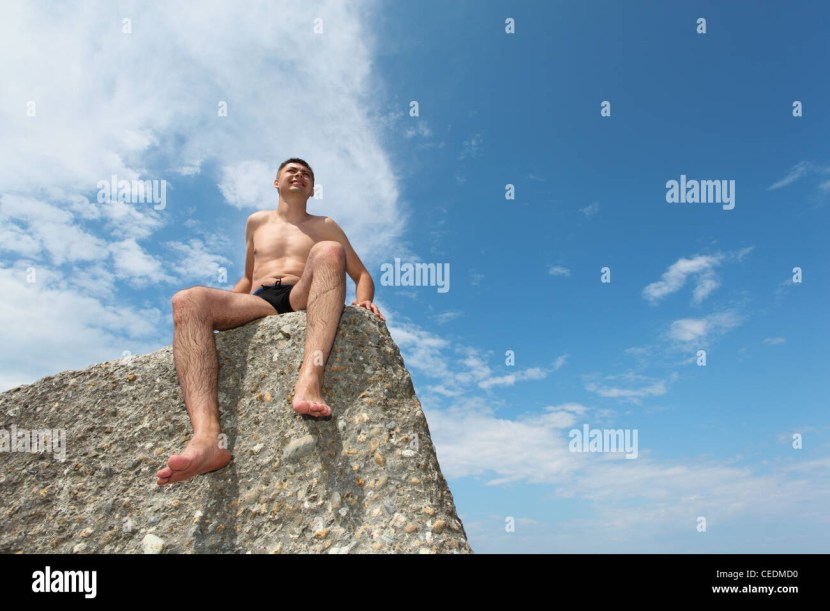 Naked man on a rock