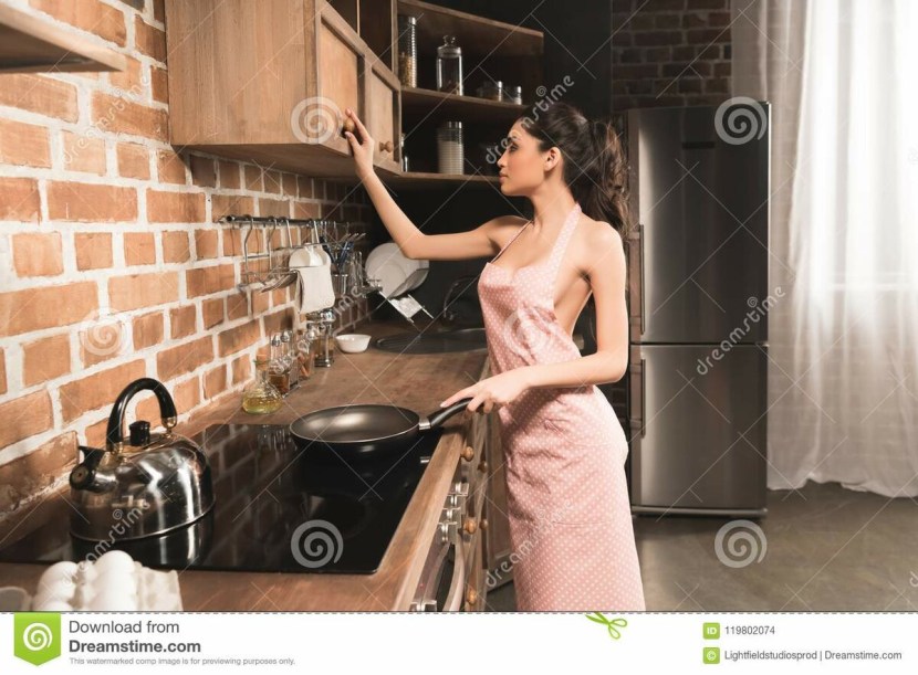 Girl in a apron in the kitchen