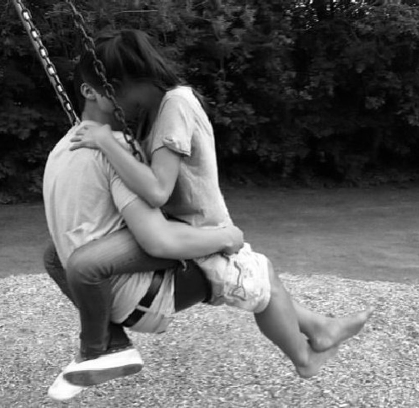 Boy and girl on a swing