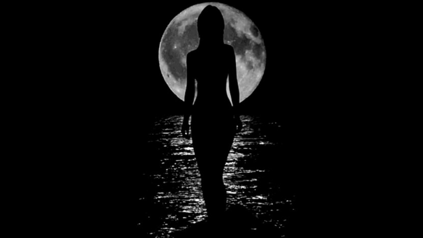 Girl against the background of the moon