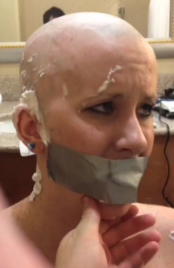 Naked woman shaves her head