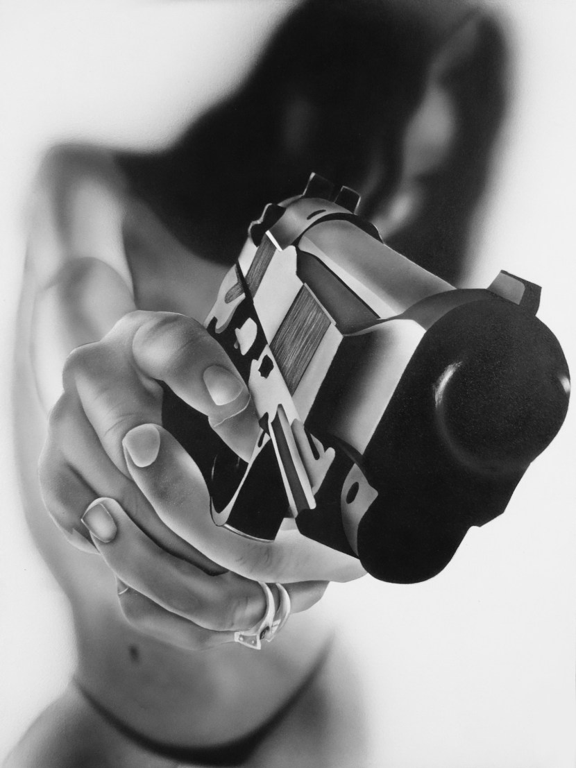 Female hand with a gun