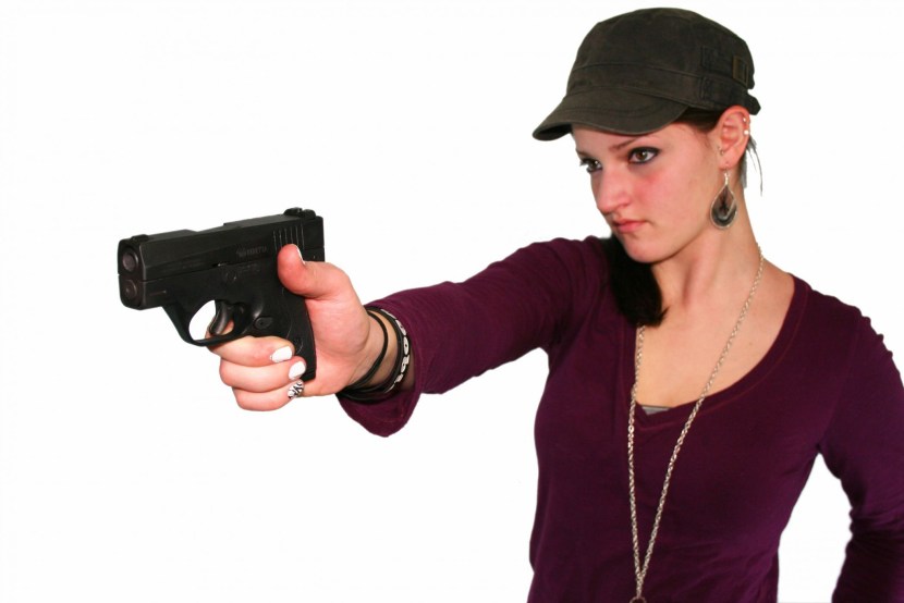 In a hood with a gun