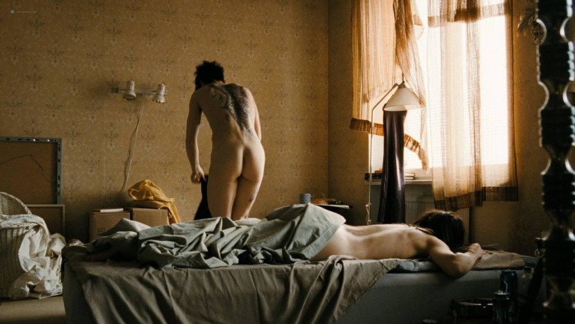 Naked Numi Rapas with a dragon tattoo