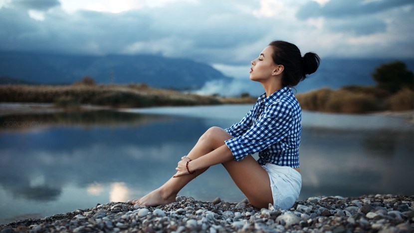 Girl sits on the shore
